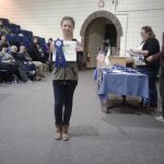 4-H member with blue ribbon and certificate