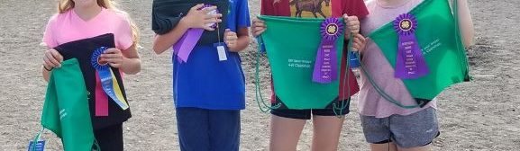 4 horse show participants with awards