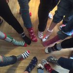4H members and a picture of their feet with holiday socks on