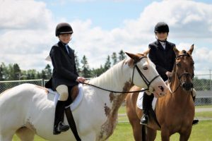 2 girls with their horses
