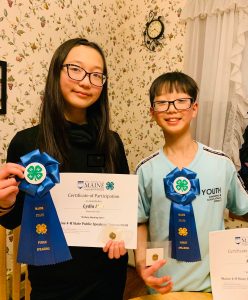 boy and girl with blue ribbons and certificates