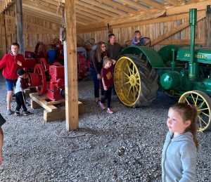 4-H youth visiting an ag museum and seeing some tractors