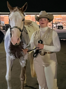 female 4H member and her horse at horse show
