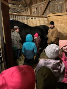 4-H youth in a horse barn listening about mares