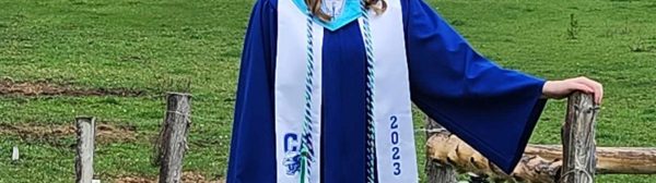 female 4-H'er in graduation cap and gown