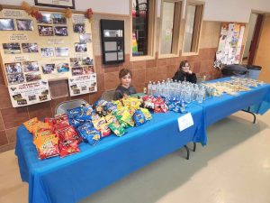 two children selling chips and snacks for a fundraiser