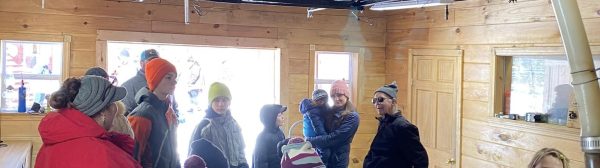 youth and adults learning about making maple syrup