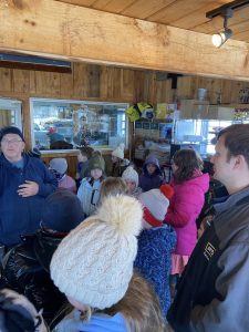 youth and adult learning about making maple syrup
