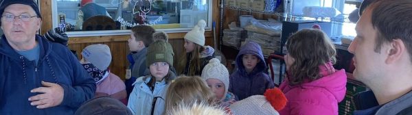 youth and adult learning about making maple syrup