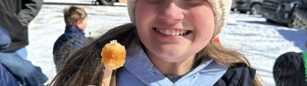 girl enjoying maple taffy