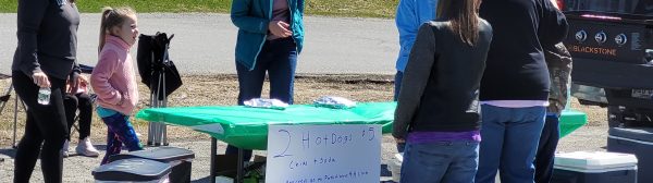 youth and adults selling hot dog lunch