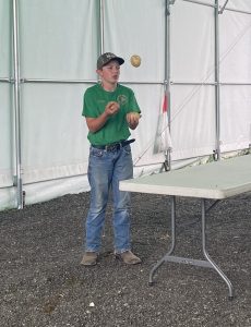 boy juggling potatoes