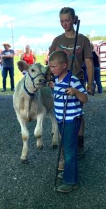 young boy showing calf