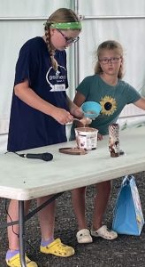 two girls doing a demonstration on an icecream sundae