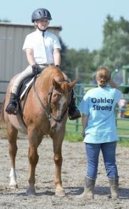 girl on horse and a girl holding the horse