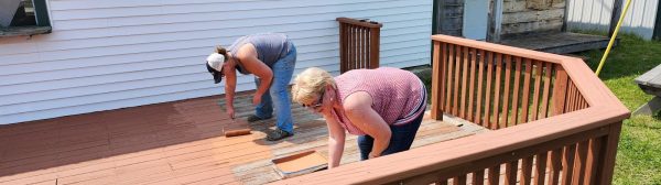 volunteers painting the deck of the food booth