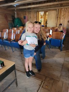 girl receiving a 4-H award from the 4-H professional