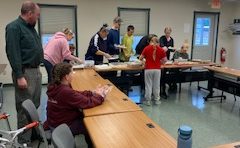 4-H members and adults preparing for their food giveaway