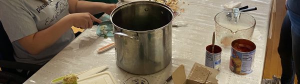 kids at a table chopping vegetables for a homemade salsa