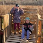 2 4-H members standing in a compost bin frame