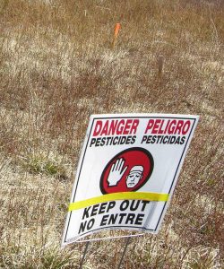 Pesticide Keep out Warning Sign in Blueberry field