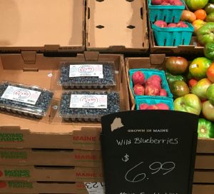 freshly packed wild blueberries on a store shelf for $6.99 a package