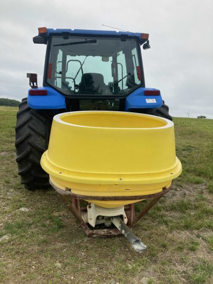 sulfur spreader attached to a tractor