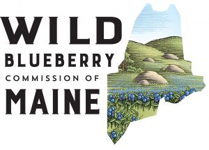 Wild blueberry commission of Maine logo showing low hills behind rocks and blueberry plants