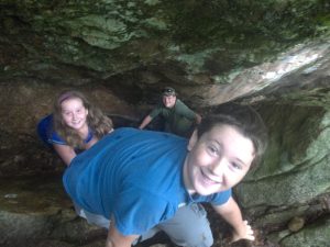 campers explore a rock cave