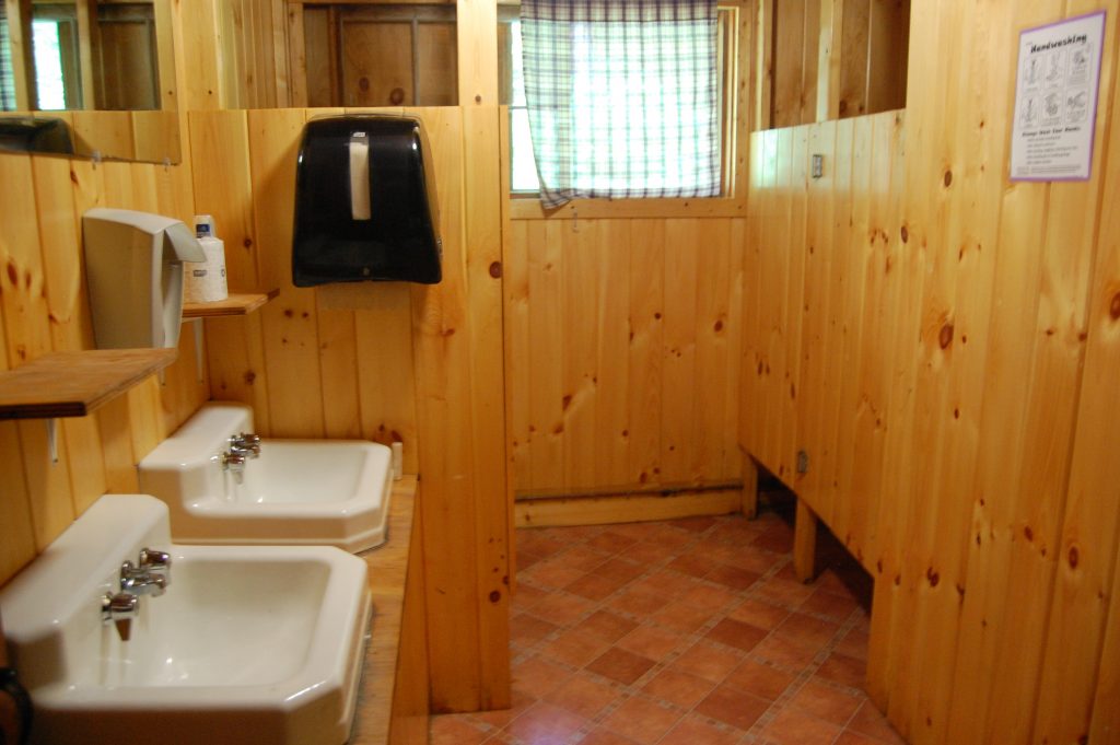 bathroom with multiple sinks and stalls