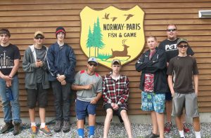 campers in front of Norway-Paris Fish & Game sign