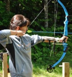 camper shooting a bow