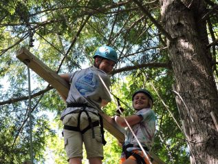 Two campers on a high ropes element