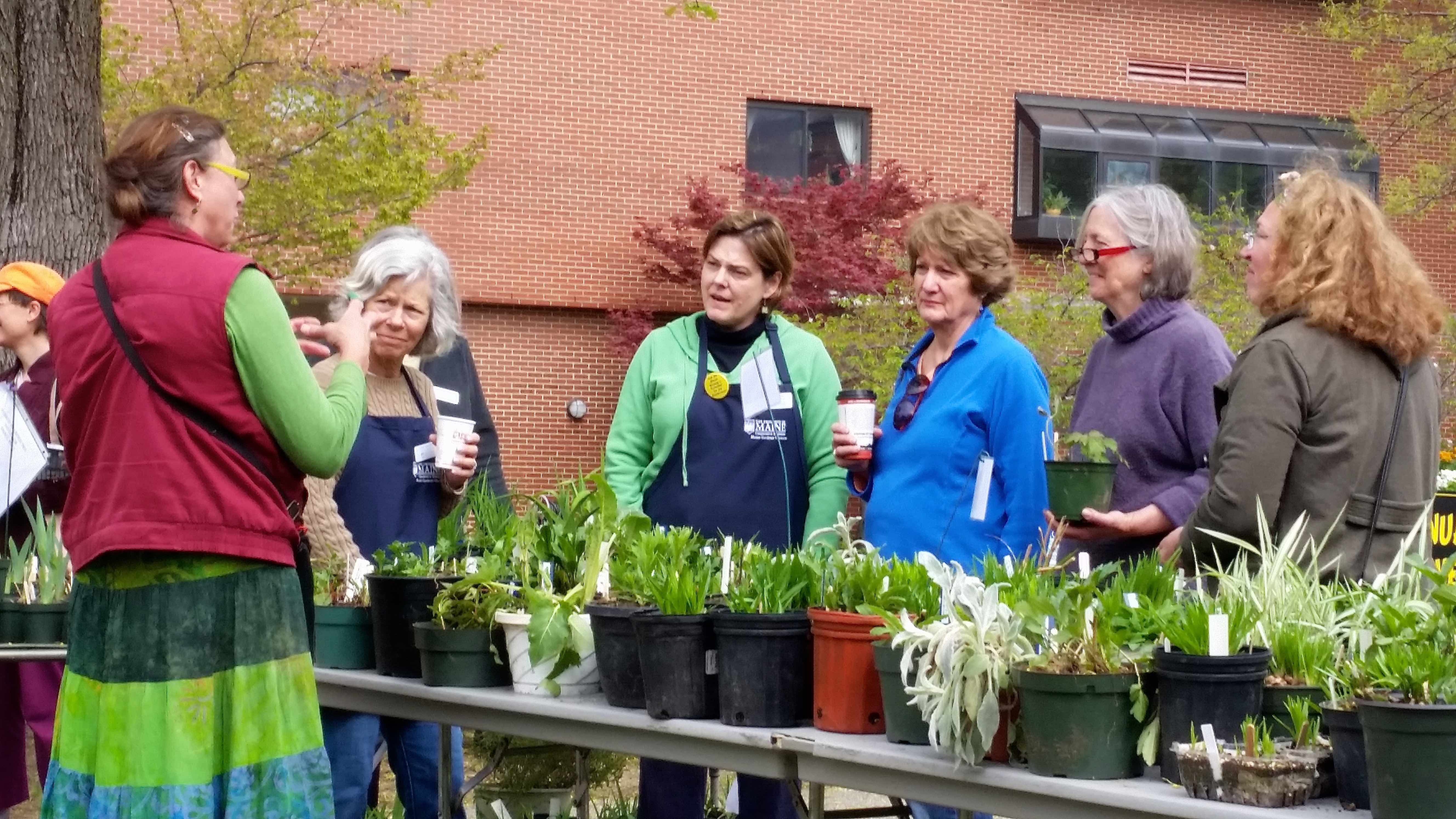 Master Gardeners helping customers shop for plants
