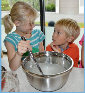 Two Children stirring a mixing bowl