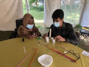 two 4-H members help each other make a science experiment