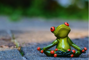 A cartoon frog in a yoga pose.