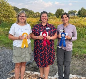 3 bakers pose with their award ribbons from the pie bake-off