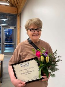 Nancy Sarnacki with her award and flowers