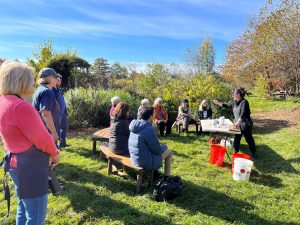 Extension staff giving a presentation at an outdoor garden