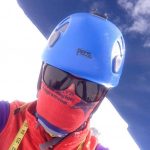 Kit Hamley wearing sun glasses, helmet, and scarf