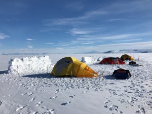 Snow walls protect tents from the wind out on the ice sheet