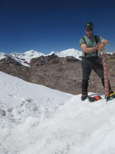 Climate Scientist Charles Rodda at the field site with the Andes in the background.