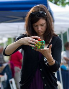woman with pint of cherry tomatoes at a farmers market