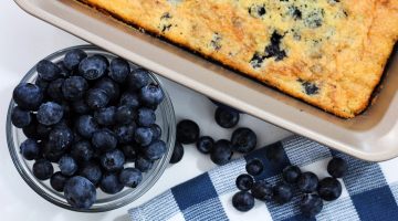 Blueberry cobbler with dish of fresh blueberries