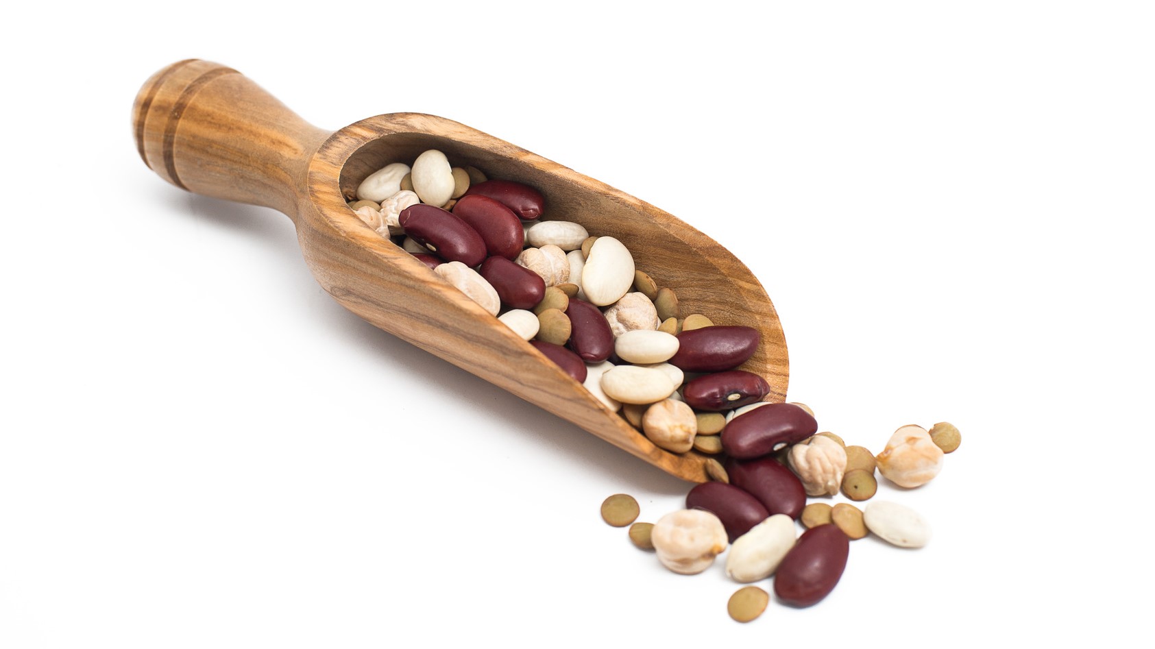 Picture of legumes in wooden scoop on white background.