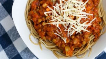Picture of Lentil Spaghetti Sauce on top of whole wheat spaghetti in a white bowl