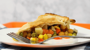 Slice of chickpea pot pie on a white plate