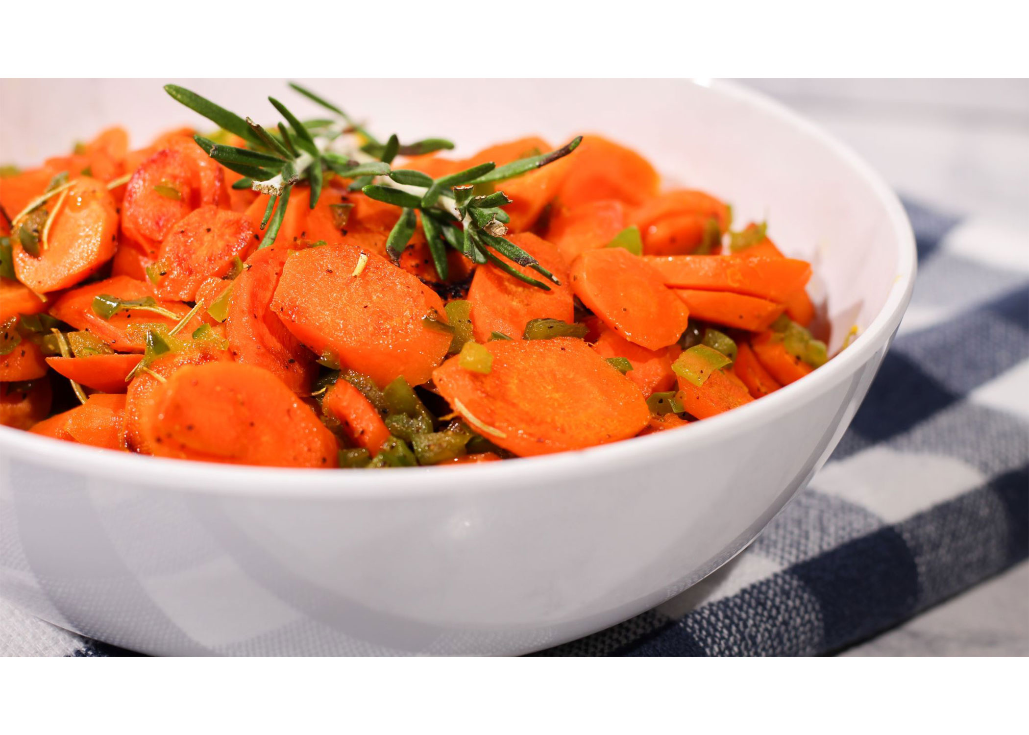 carrots with rosemary sprig in a bowl