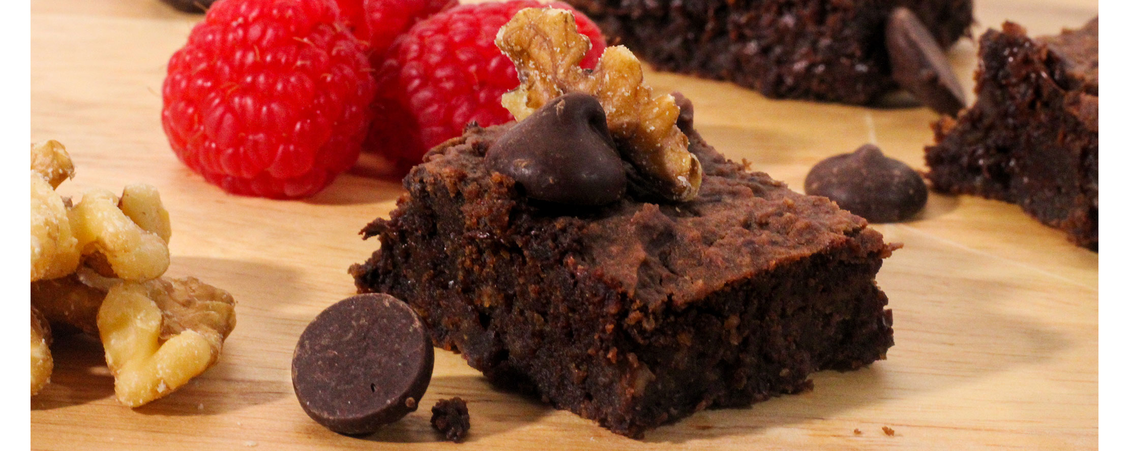 Black bean brownie with walnuts, chocolate chips, and raspberries on the side
